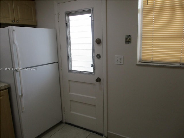 entryway with light tile patterned flooring