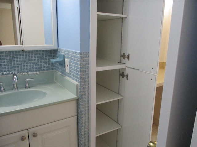 bathroom with decorative backsplash and vanity