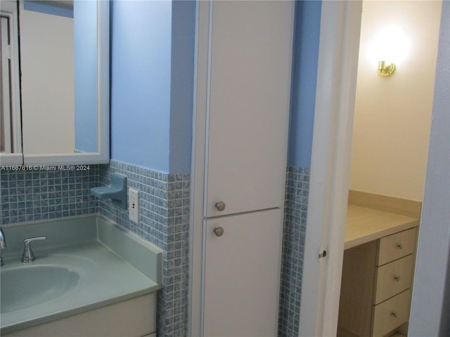 bathroom with tile walls and vanity