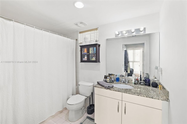 bathroom with vanity, toilet, and tile patterned floors