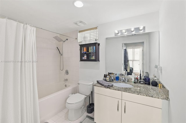 full bathroom featuring tile patterned flooring, vanity, toilet, and shower / bath combo with shower curtain