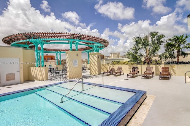 view of pool with a patio and a pergola