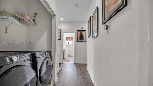 washroom featuring wood-type flooring and washing machine and clothes dryer