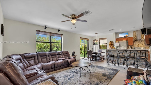 living room featuring ceiling fan and light tile patterned floors