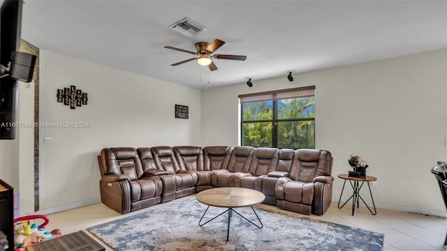 living room featuring ceiling fan and light tile patterned floors