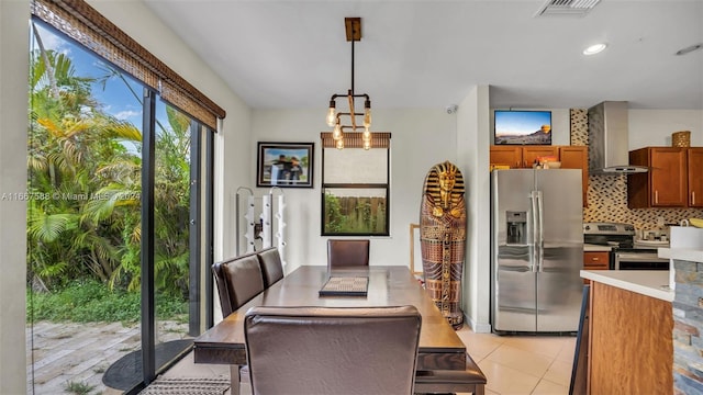 dining area with an inviting chandelier and light tile patterned floors