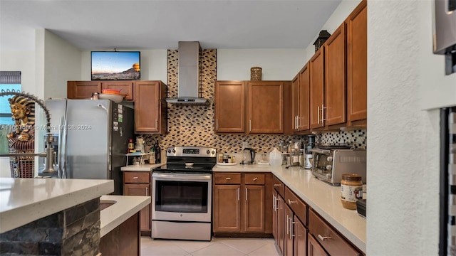 kitchen with backsplash, wall chimney exhaust hood, light tile patterned floors, and stainless steel appliances