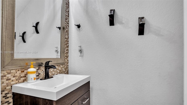 bathroom featuring vanity and backsplash