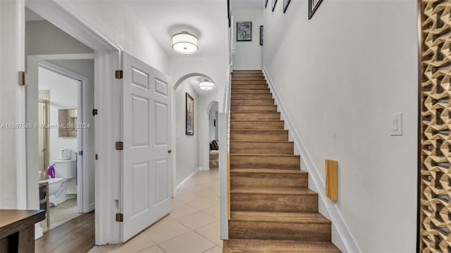 stairs featuring tile patterned flooring