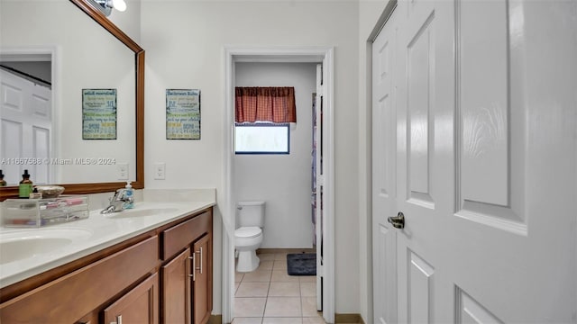 bathroom with vanity, tile patterned flooring, and toilet