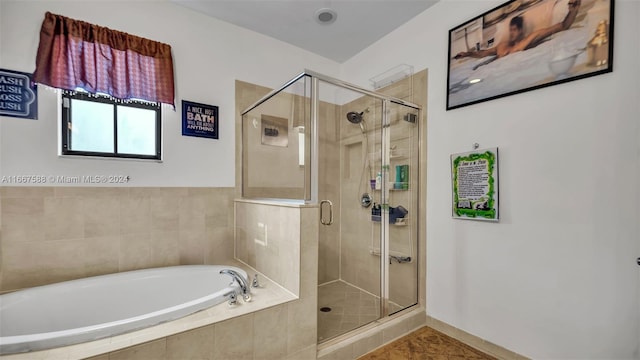 bathroom with tile patterned flooring and separate shower and tub