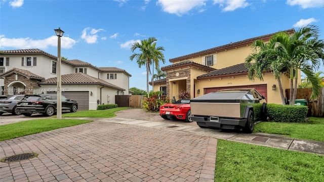 mediterranean / spanish house with a front yard and a garage