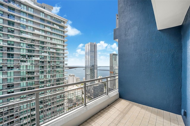 balcony featuring a city view and a water view