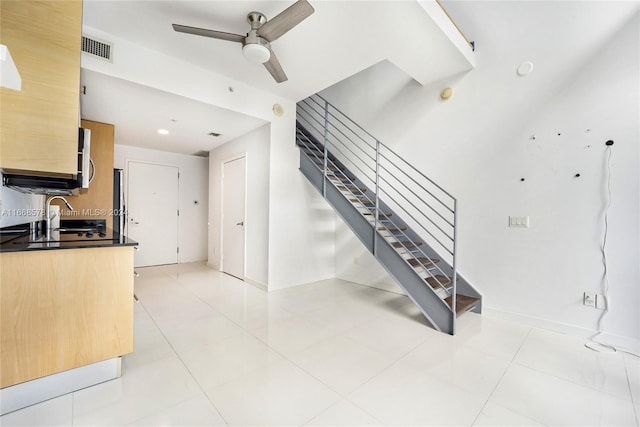 staircase with tile patterned floors and ceiling fan