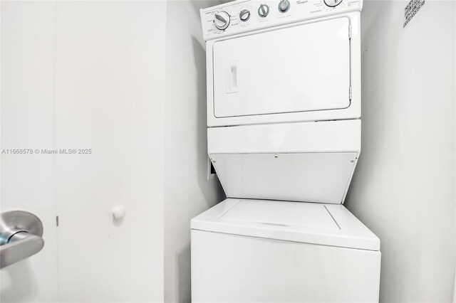 washroom with laundry area and stacked washer / dryer