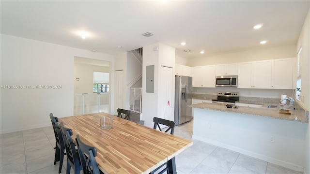 dining area with light tile patterned floors and sink