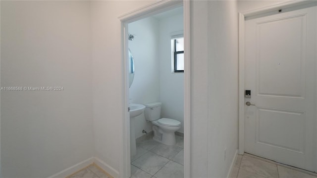 bathroom with tile patterned flooring and toilet