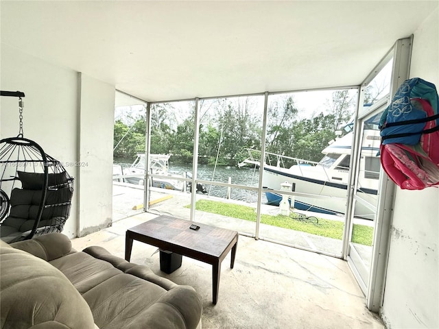 sunroom featuring a water view and a wealth of natural light