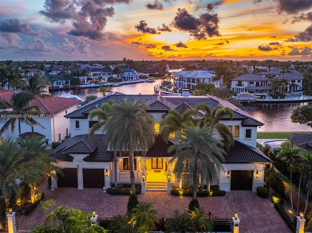 aerial view at dusk with a water view