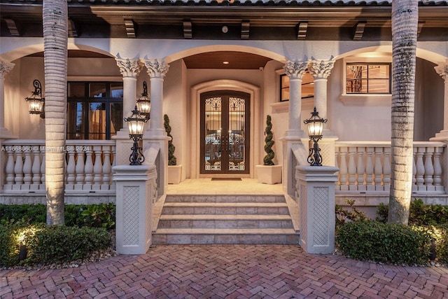 view of exterior entry featuring french doors