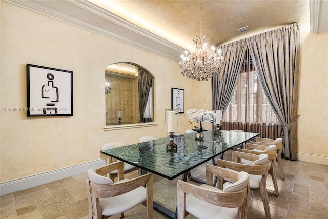 dining space featuring ornamental molding and a chandelier