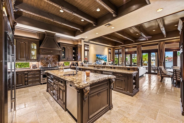 kitchen with sink, a center island with sink, custom range hood, and wood ceiling