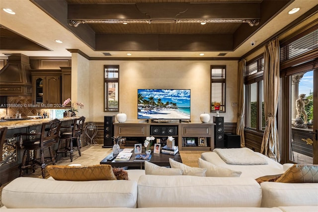 living room with a tray ceiling and beam ceiling