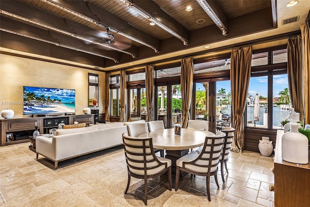 dining room with wooden ceiling, a water view, and beamed ceiling