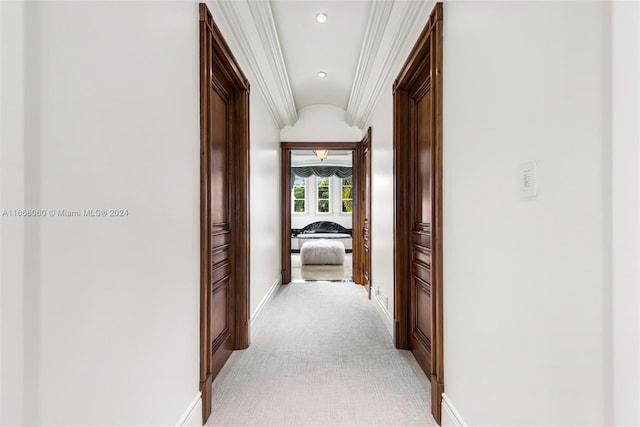 hall featuring ornamental molding and light colored carpet