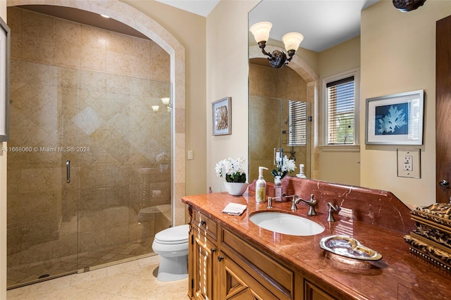 bathroom with tile patterned flooring, vanity, toilet, and an enclosed shower