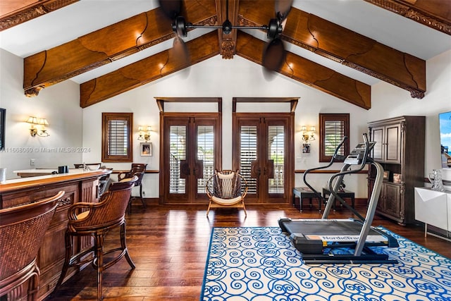 exercise room with dark wood-type flooring, ceiling fan, vaulted ceiling, and french doors