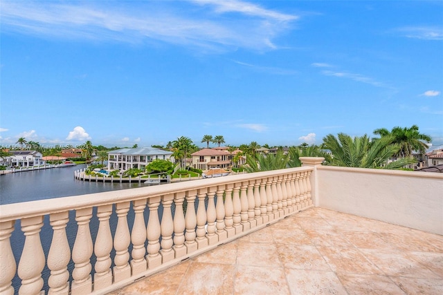 view of patio with a balcony and a water view