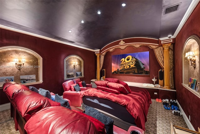 carpeted home theater room featuring crown molding