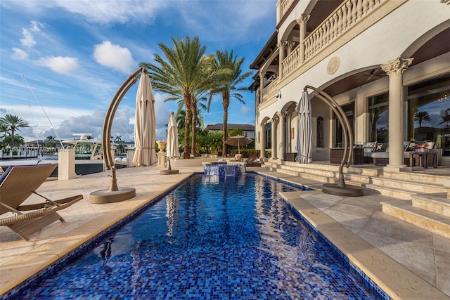 view of pool featuring ceiling fan and a patio area