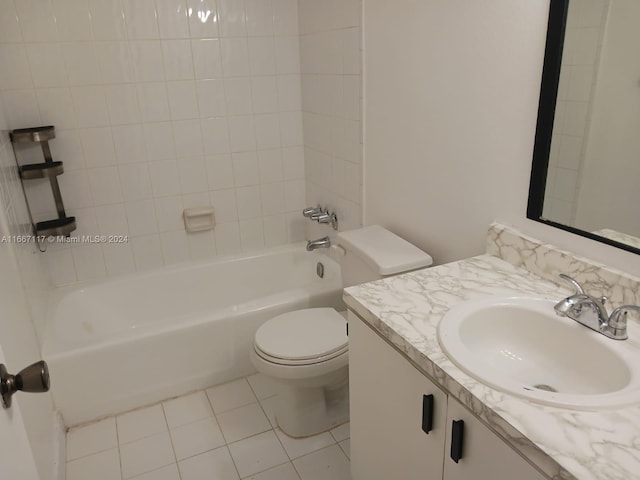 full bathroom featuring tiled shower / bath combo, vanity, tile patterned flooring, and toilet