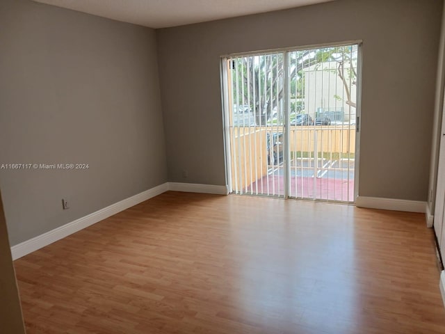 spare room with light hardwood / wood-style flooring