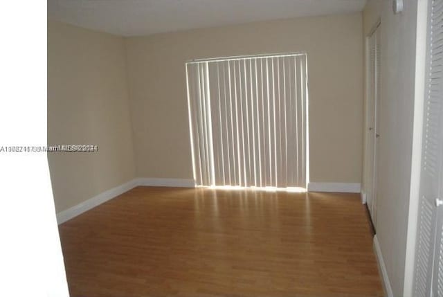 empty room with wood-type flooring