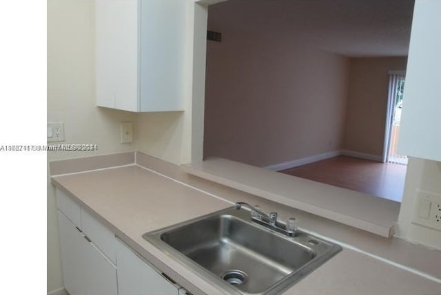 kitchen with sink and white cabinetry