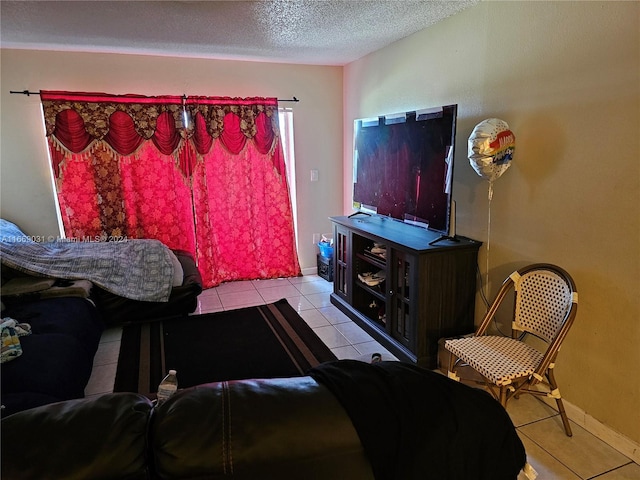 bedroom with a textured ceiling and light tile patterned floors