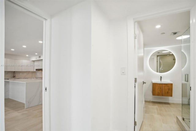 bathroom with vanity and wood-type flooring