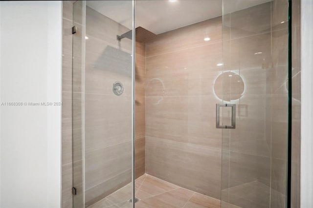 bathroom with a shower with door