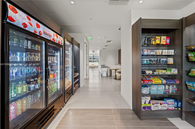 hallway featuring light tile patterned floors and beverage cooler