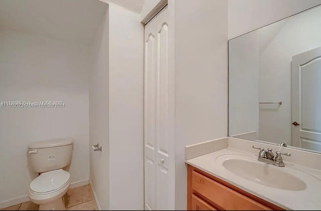 bathroom featuring vanity, toilet, and tile patterned floors