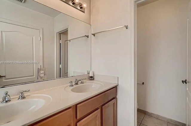 bathroom featuring tile patterned flooring and vanity