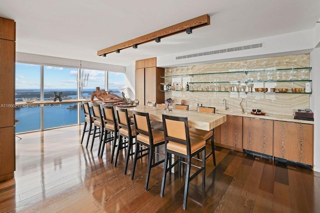 450 Alton Rd Unit Ph2, Miami Beach, FL 33139 - dining room featuring dark wood-style flooring and bar