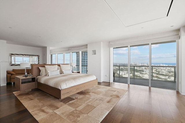 bedroom with access to outside, light hardwood / wood-style flooring, and multiple windows