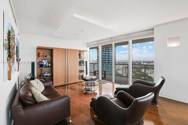 living room featuring floor to ceiling windows and hardwood / wood-style floors