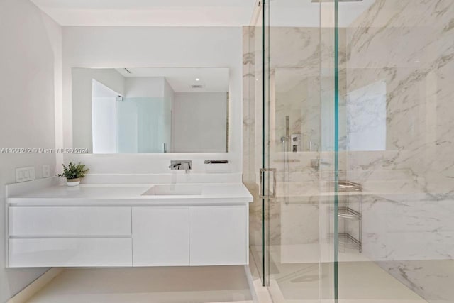 bathroom featuring vanity and an enclosed shower