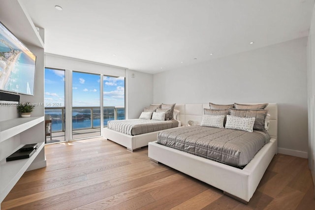 450 Alton Rd Unit Ph2, Miami Beach, FL 33139 - bedroom featuring access to exterior, a water view, and wood finished floors