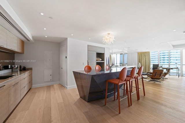 450 Alton Rd Unit Ph2, Miami Beach, FL 33139 - kitchen with modern cabinets, light wood-style floors, a breakfast bar area, open floor plan, and recessed lighting